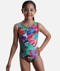 Mondor VIVID 7822 girls’ sleeveless gymnastics leotard with multicoloured abstract patches, fine heart outlines and a round neckline.