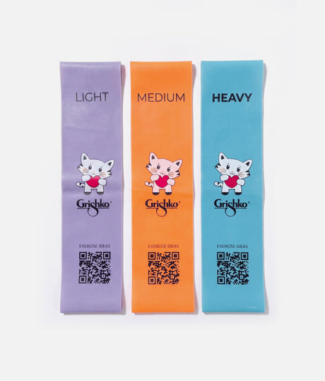Three Grishko brand resistance bands in light purple, orange, and light blue, labeled LIGHT, MEDIUM, and HEAVY, with cartoon cat graphics and QR codes on a white background.