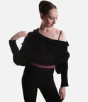 Black Mirella Adagio warm-up scarf worn as a cropped bolero, showing long sleeves and a twisted drape over a plum leotard.