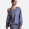 Mirella Adagio M30019L sweatshirt in Dusty Grey, worn off one shoulder with long sleeves and matching wide leg sweatpants.