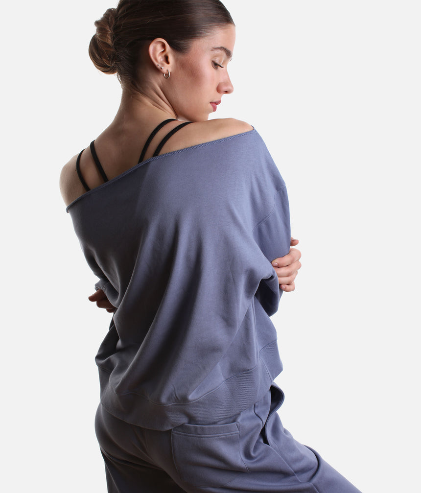 Mirella Adagio M30019L sweatshirt in Dusty Grey, worn off one shoulder with long sleeves and matching wide leg sweatpants.