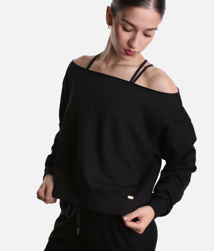 Mirella Adagio M30019L sweatshirt in Black, worn off one shoulder with long sleeves and matching wide leg sweatpants.