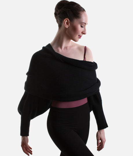 Black Mirella Adagio warm-up scarf worn as a cropped bolero, showing long sleeves and a twisted drape over a plum leotard.