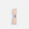 Overhead view of pale peach-pink Tendu Stretchy Ribbon, folded lengthways with its labelled paper band at the centre.