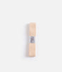 Overhead view of pale peach-pink Tendu Stretchy Ribbon, folded lengthways with its labelled paper band at the centre.