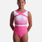 The Zone Melody Z818MEL girls’ pink and white sleeveless gymnastics leotard with bold neckline accents, ombré shading, chevron crystals and a white waist stripe.